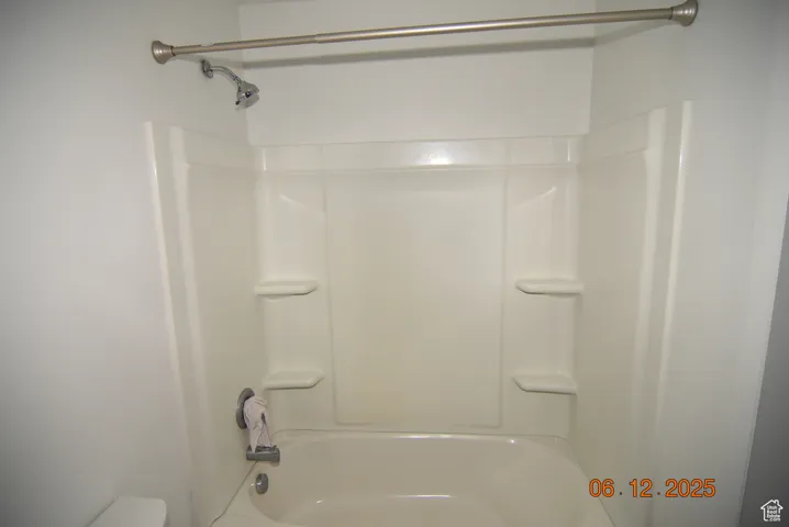 Full bathroom featuring bathing tub / shower combination, sink and toilet