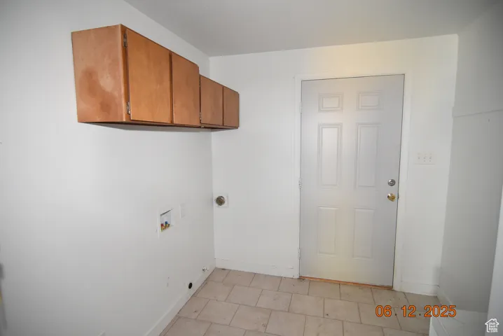 Laundry room with cabinet space and hookup for a washer and electric dryer