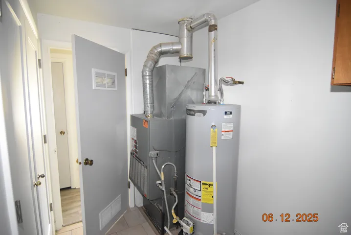Utility room with gas water heater, gas forced-air furnace with A/C