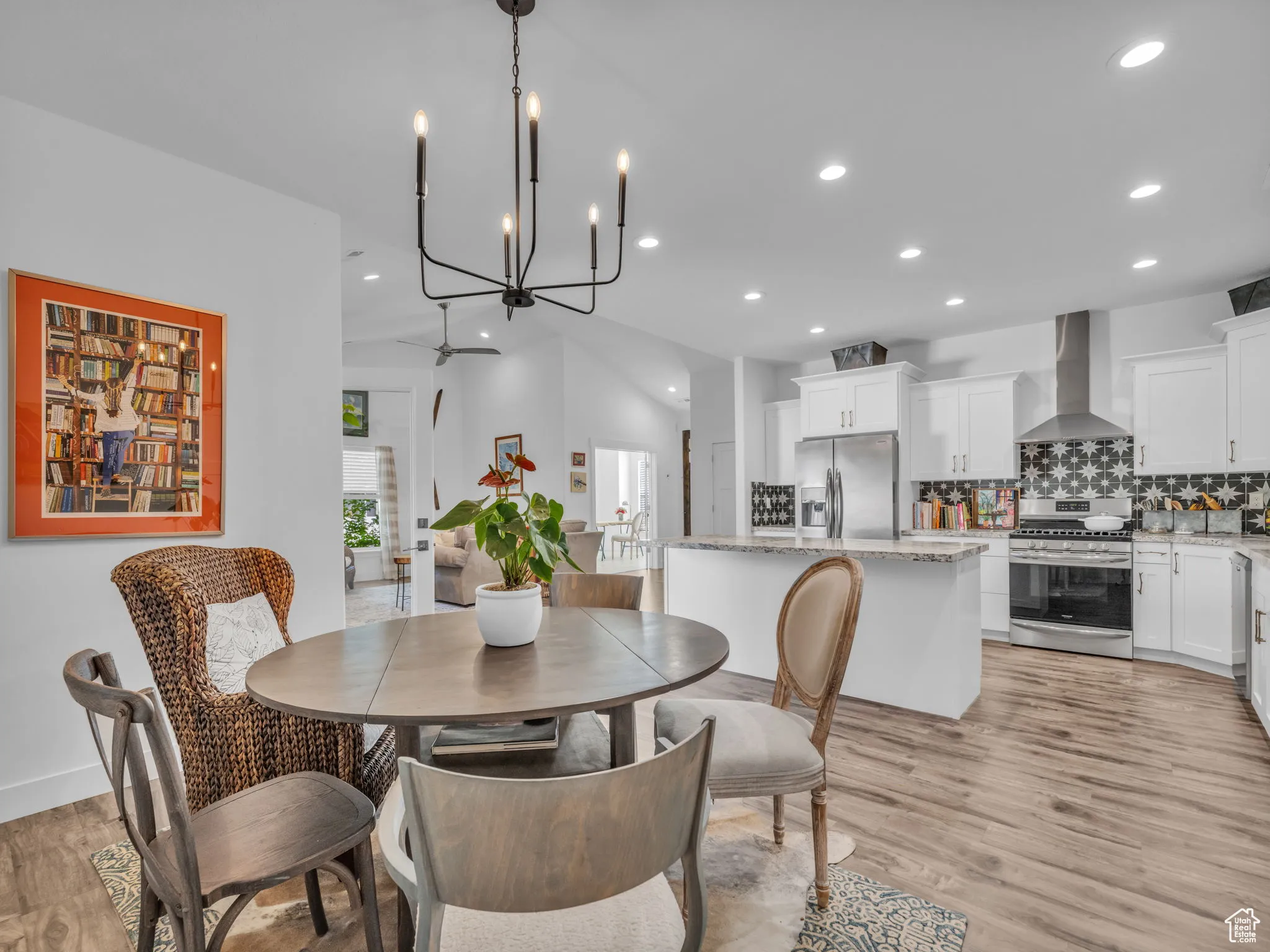 Dining space with light wood-type flooring, recessed lighting, and a chandelier