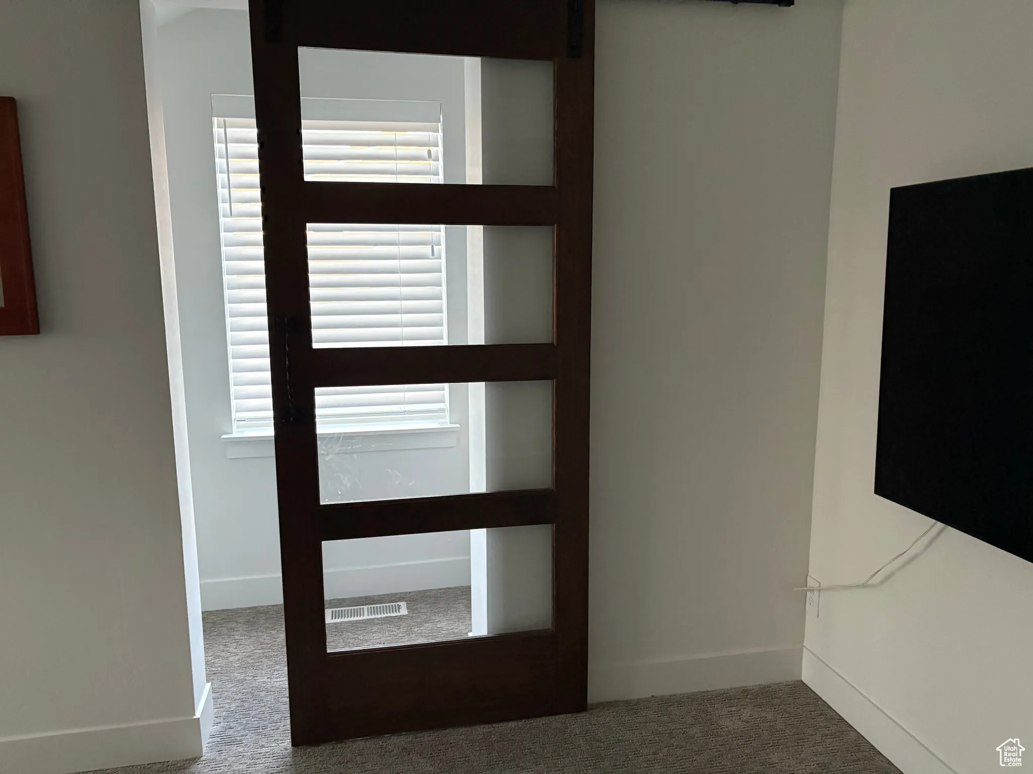Foyer entrance featuring carpet floors and a barn door