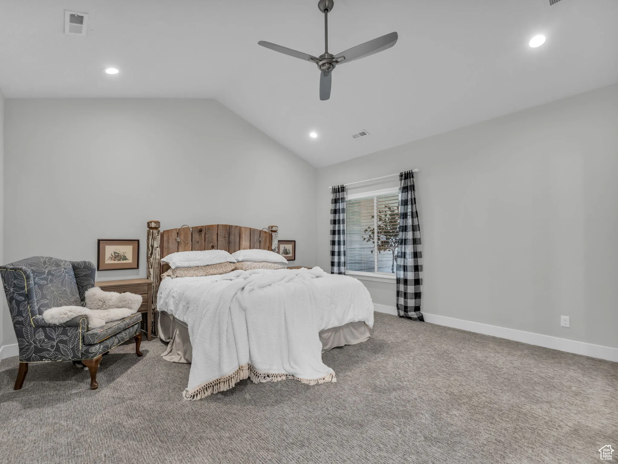 Carpeted bedroom featuring recessed lighting, vaulted ceiling, and a ceiling fan