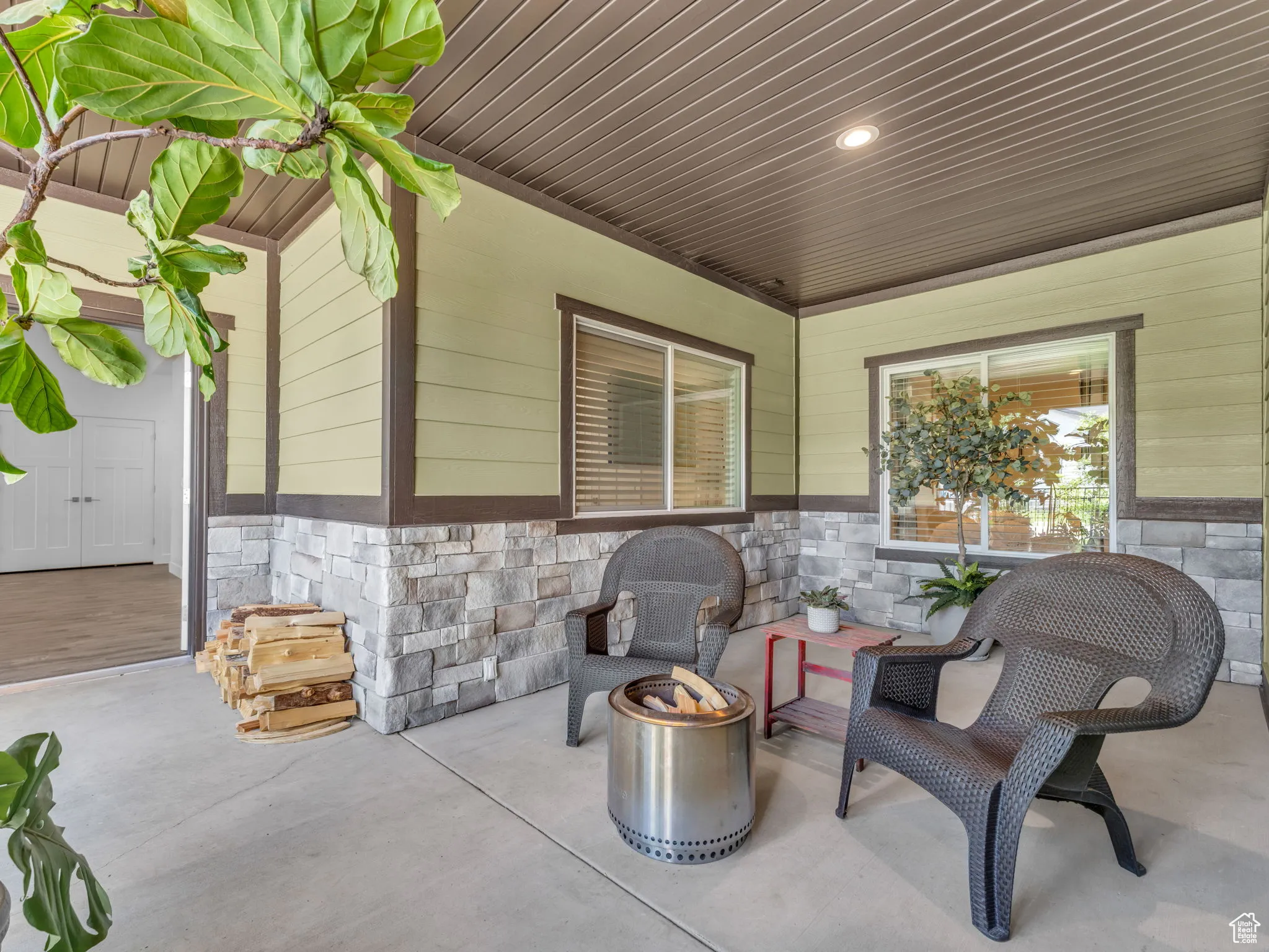 View of patio with an outdoor fire pit