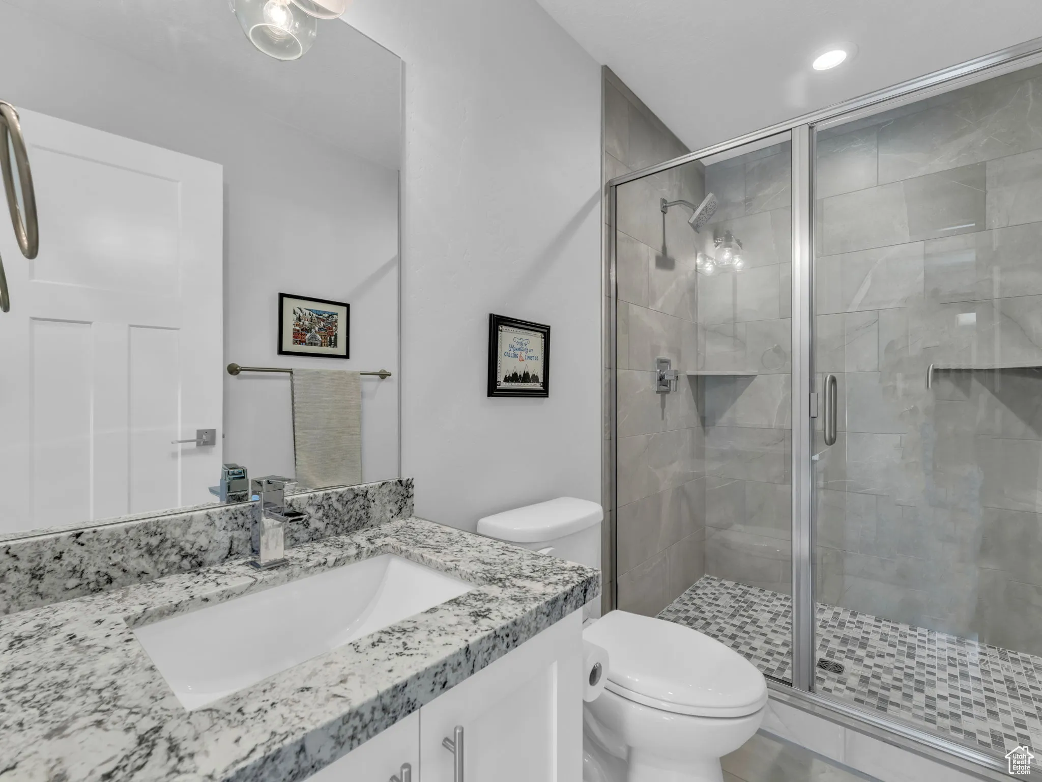 Full bath featuring vanity, a stall shower, and recessed lighting