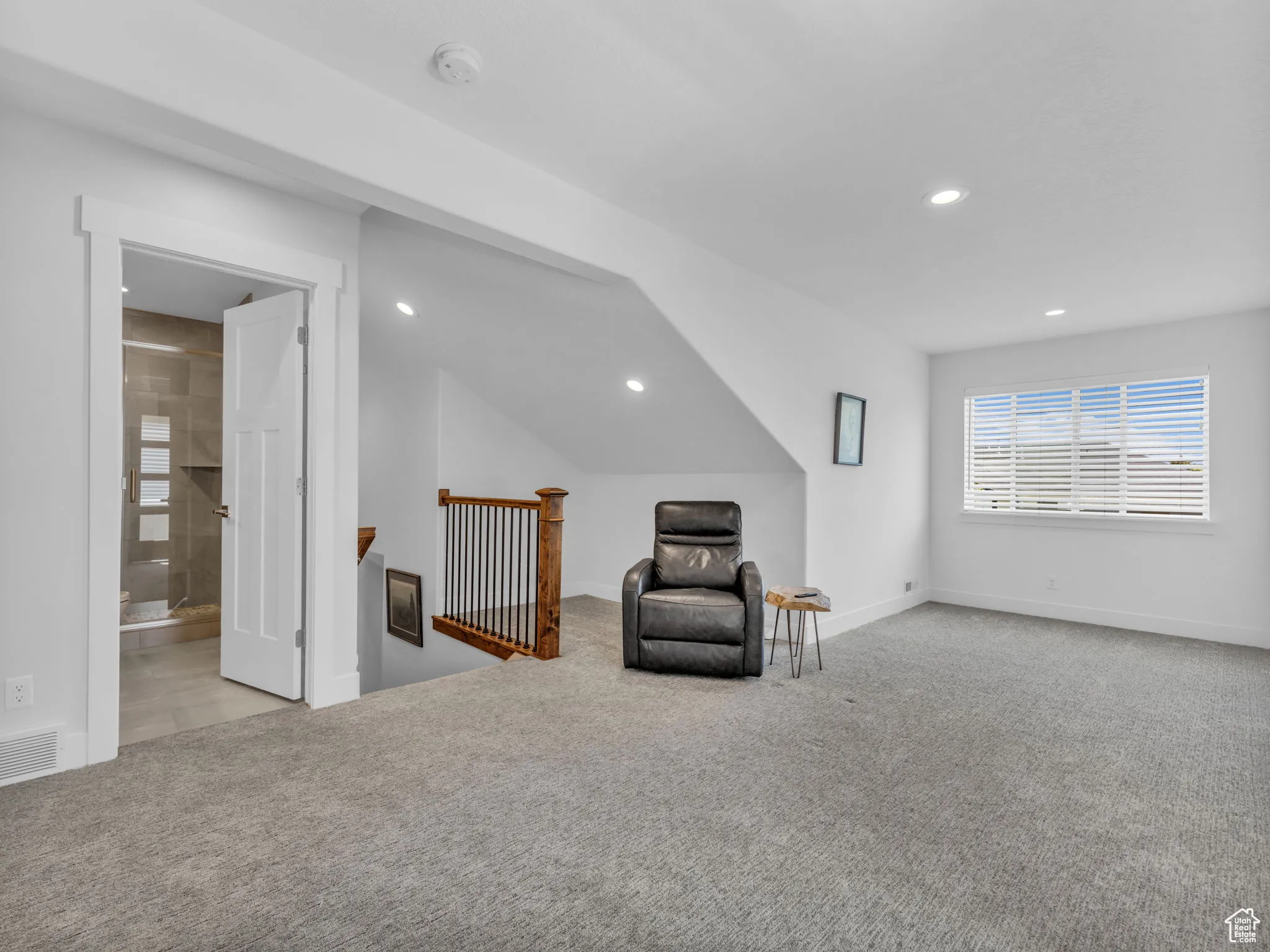 Unfurnished room with an upstairs landing, carpet floors, and recessed lighting