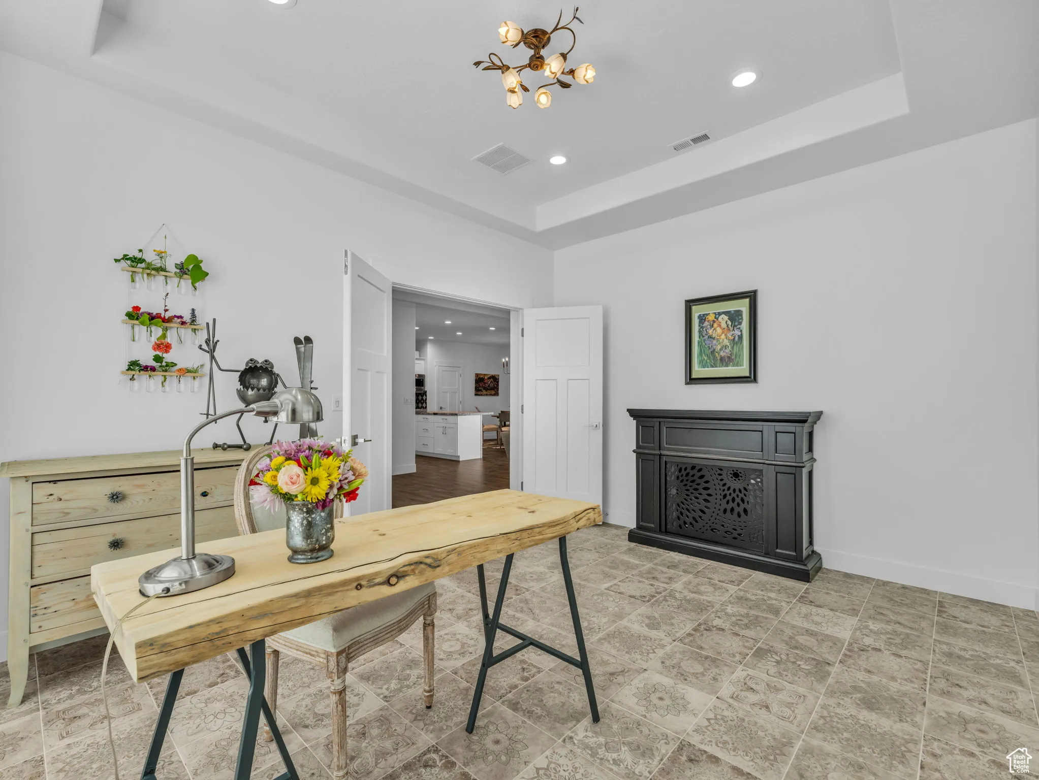 Office featuring a raised ceiling, a chandelier, and recessed lighting