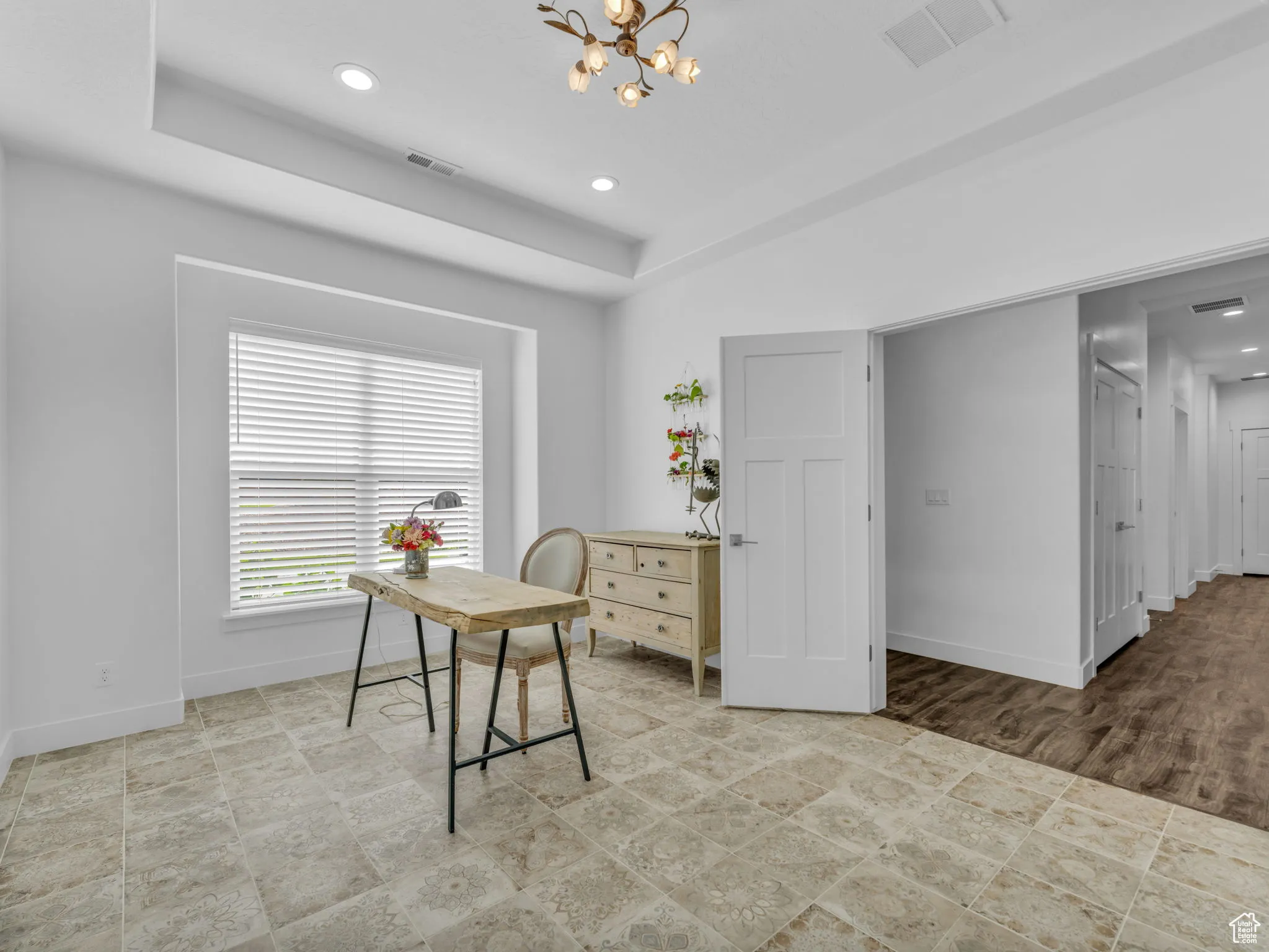 Office with a chandelier, a tray ceiling, and recessed lighting