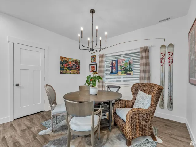 Dining area featuring a chandelier and wood finished floors