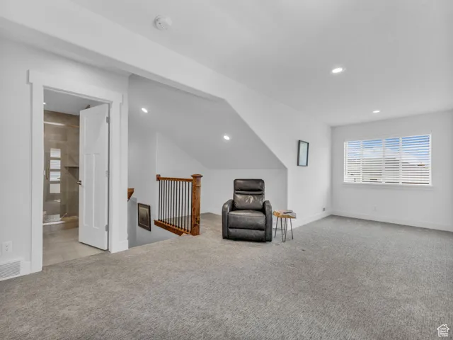 Unfurnished room with an upstairs landing, carpet floors, and recessed lighting
