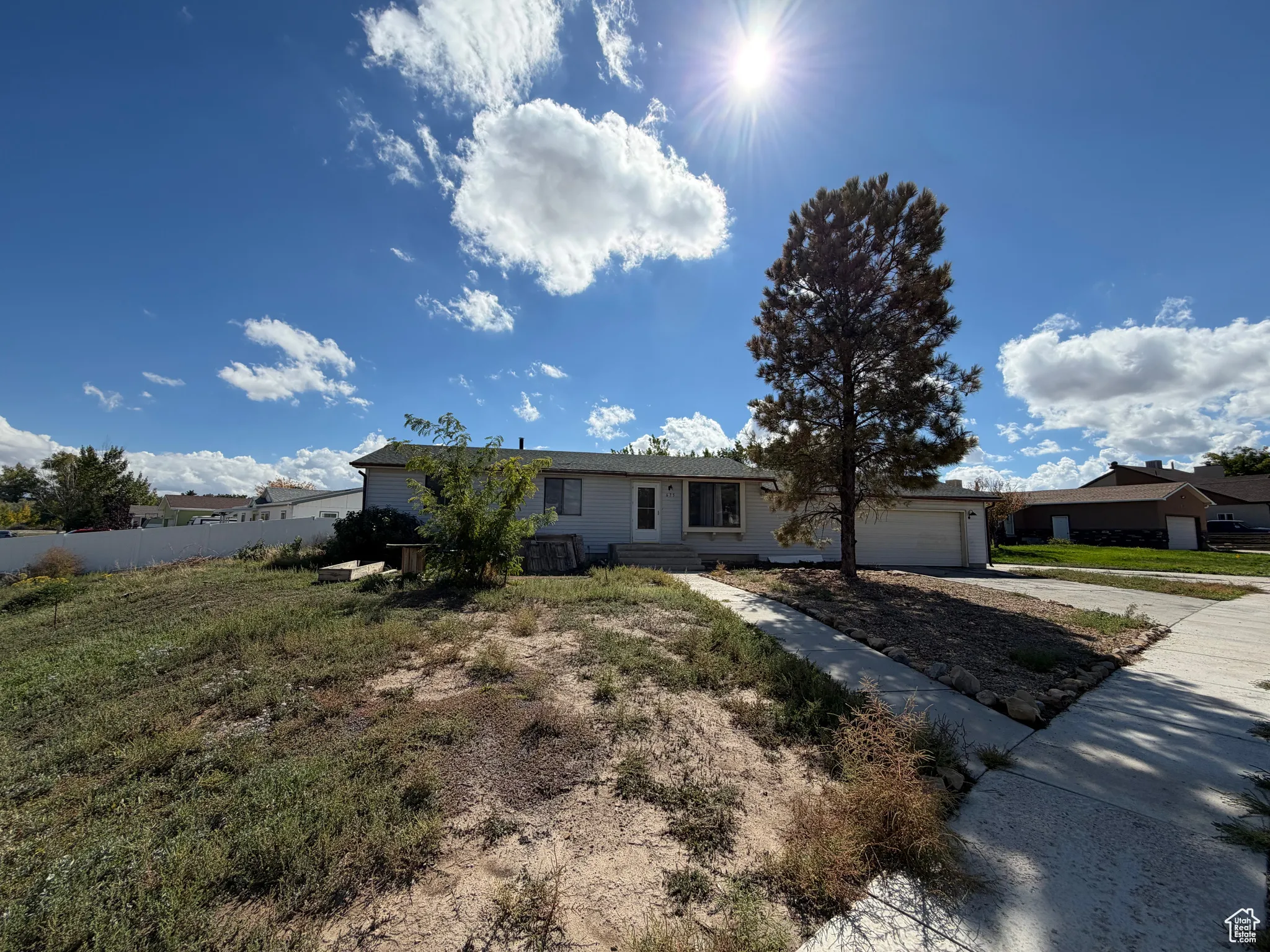 Ranch-style house with driveway and a garage