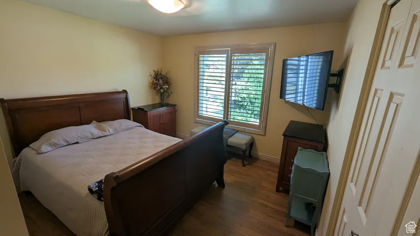 Bedroom featuring wood finished floors and baseboards