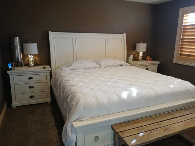 Bedroom with dark colored carpet