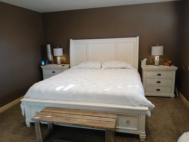 Bedroom featuring baseboards and dark colored carpet