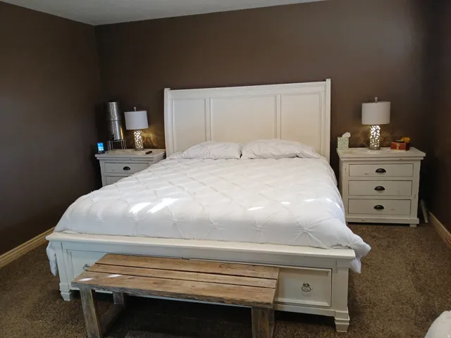 Bedroom with baseboards and dark carpet