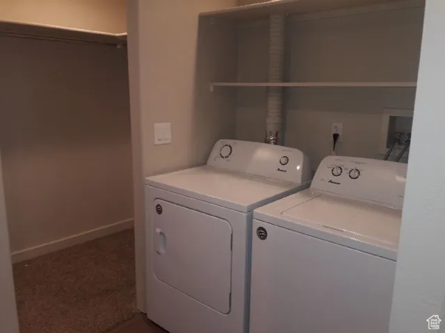 Laundry area featuring washer and dryer and carpet floors