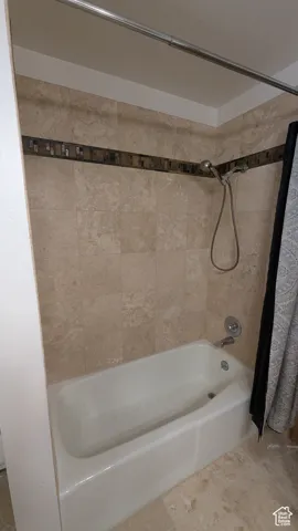 Bathroom featuring shower / tub combo with curtain