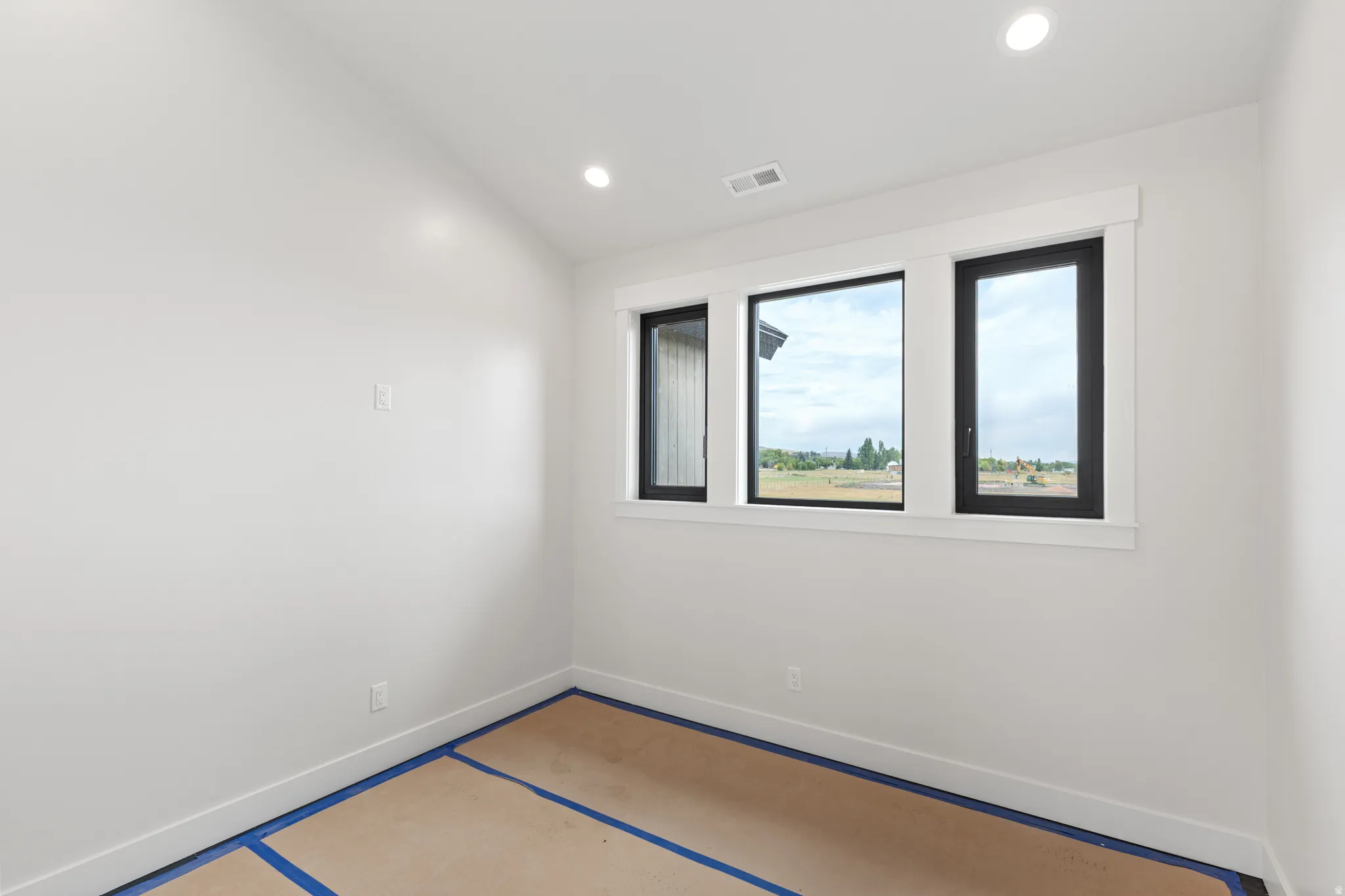 White walls with recessed lighting and multi-pane windows