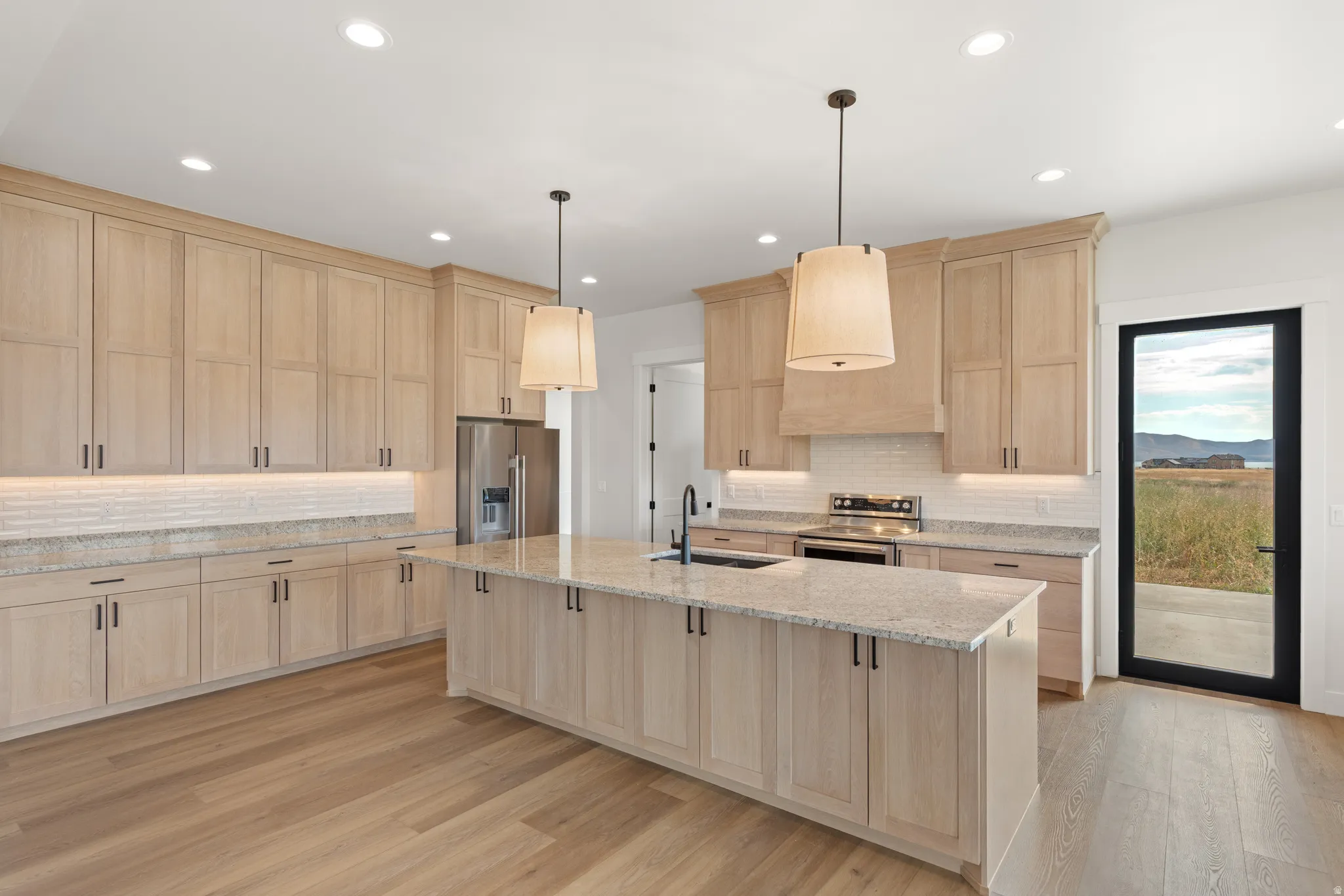 Kitchen featuring light wood cabinetry, recessed lighting, and a center island with pendant lighting