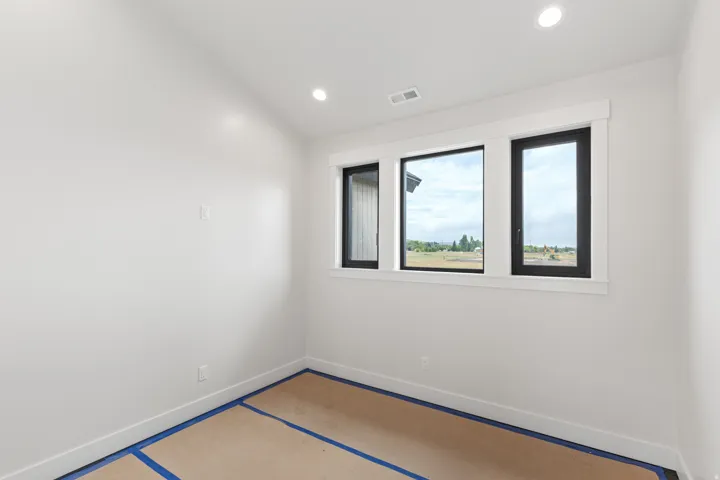 White walls with recessed lighting and multi-pane windows