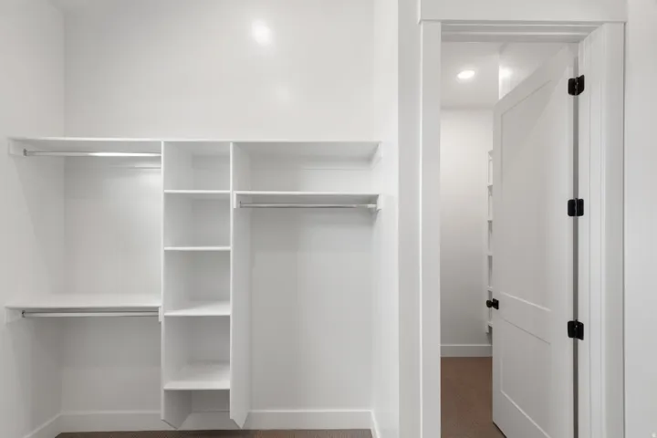 Built-in closet organization system with shelving and hanging rods