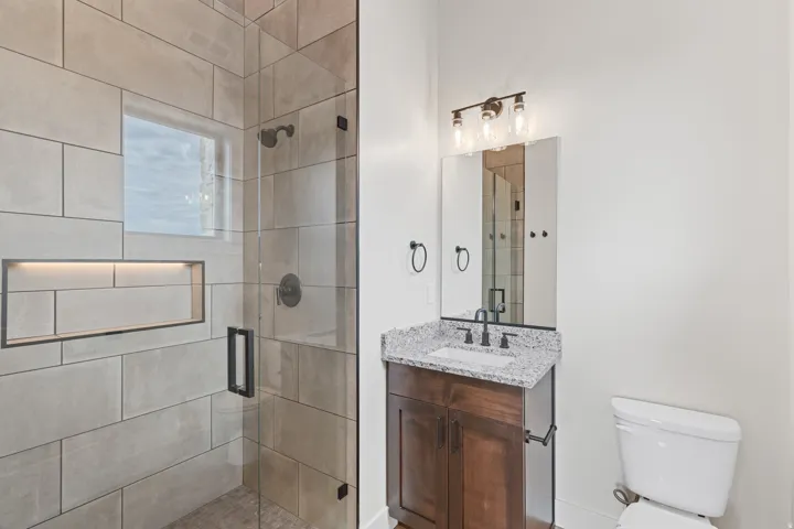 Walk-in shower with large format tile and built-in niche