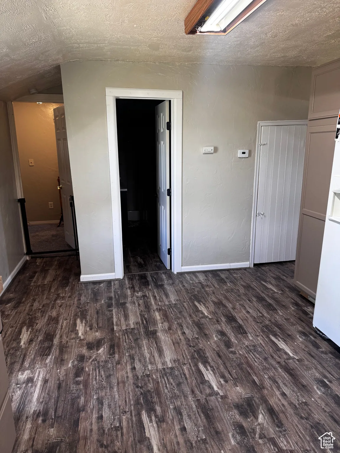Unfurnished bedroom featuring a textured ceiling and wood finished floors
