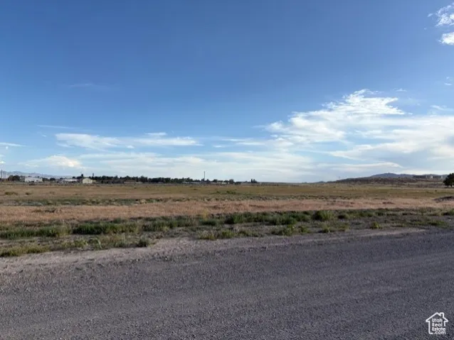 View of asphalt road featuring a view of rural / pastoral area