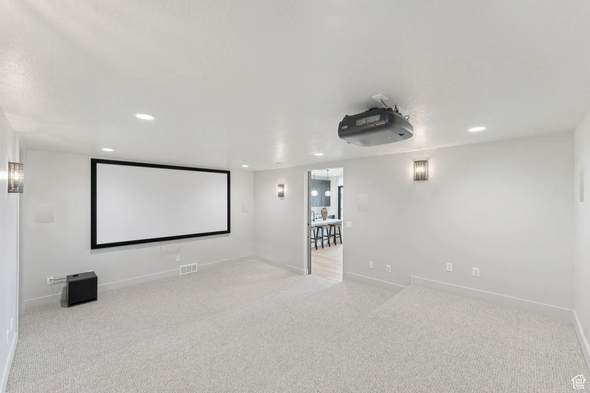 Home theater room with recessed lighting and carpet floors