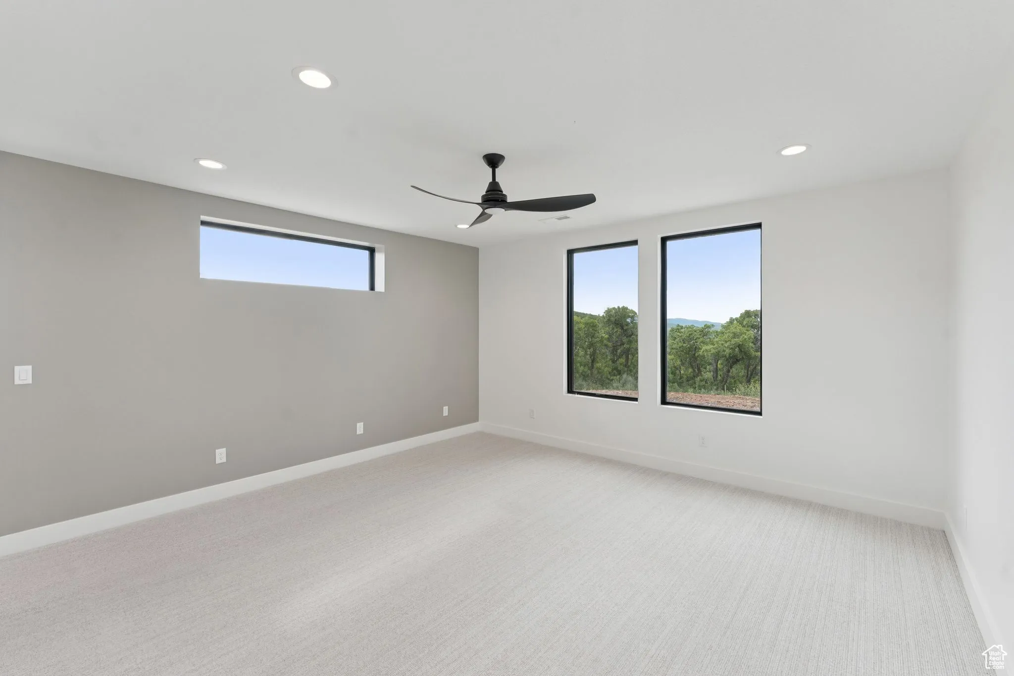 Spare room with light carpet, recessed lighting, and a ceiling fan