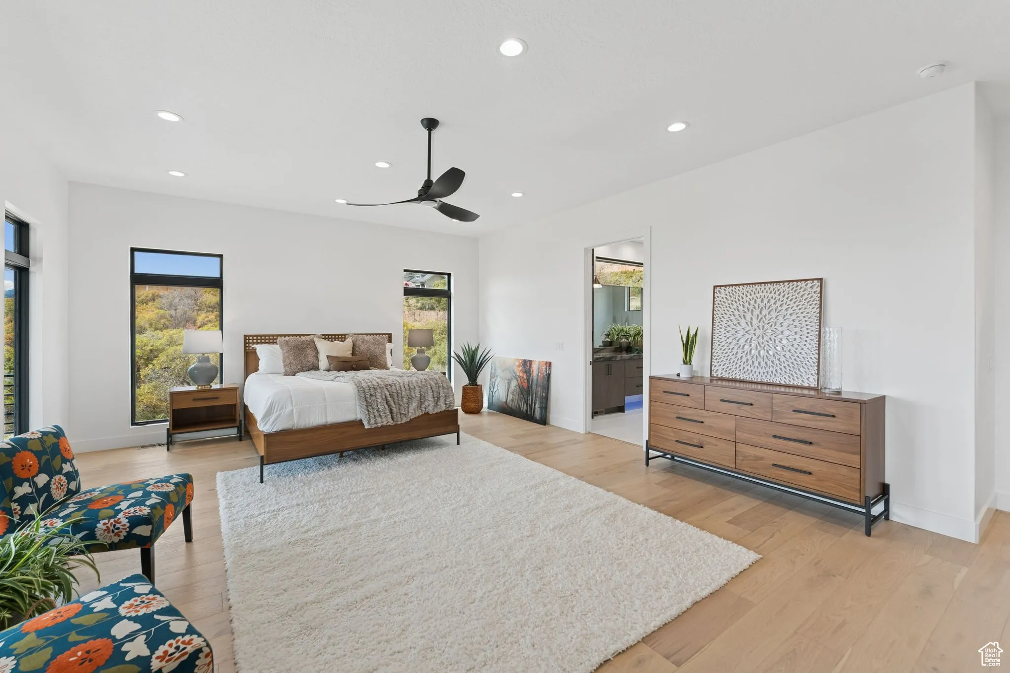 Bedroom with recessed lighting, ceiling fan, light wood finished floors, and ensuite bath