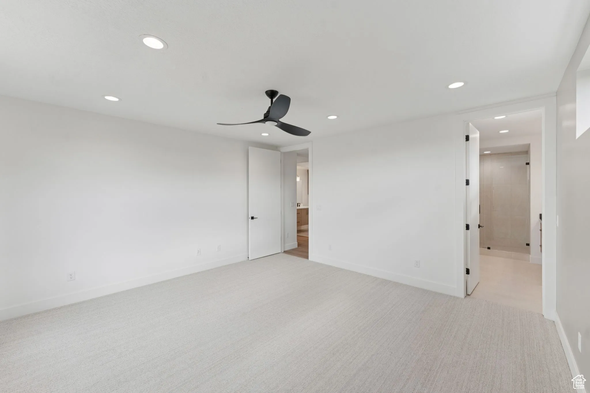 Unfurnished room with recessed lighting, a ceiling fan, and light carpet
