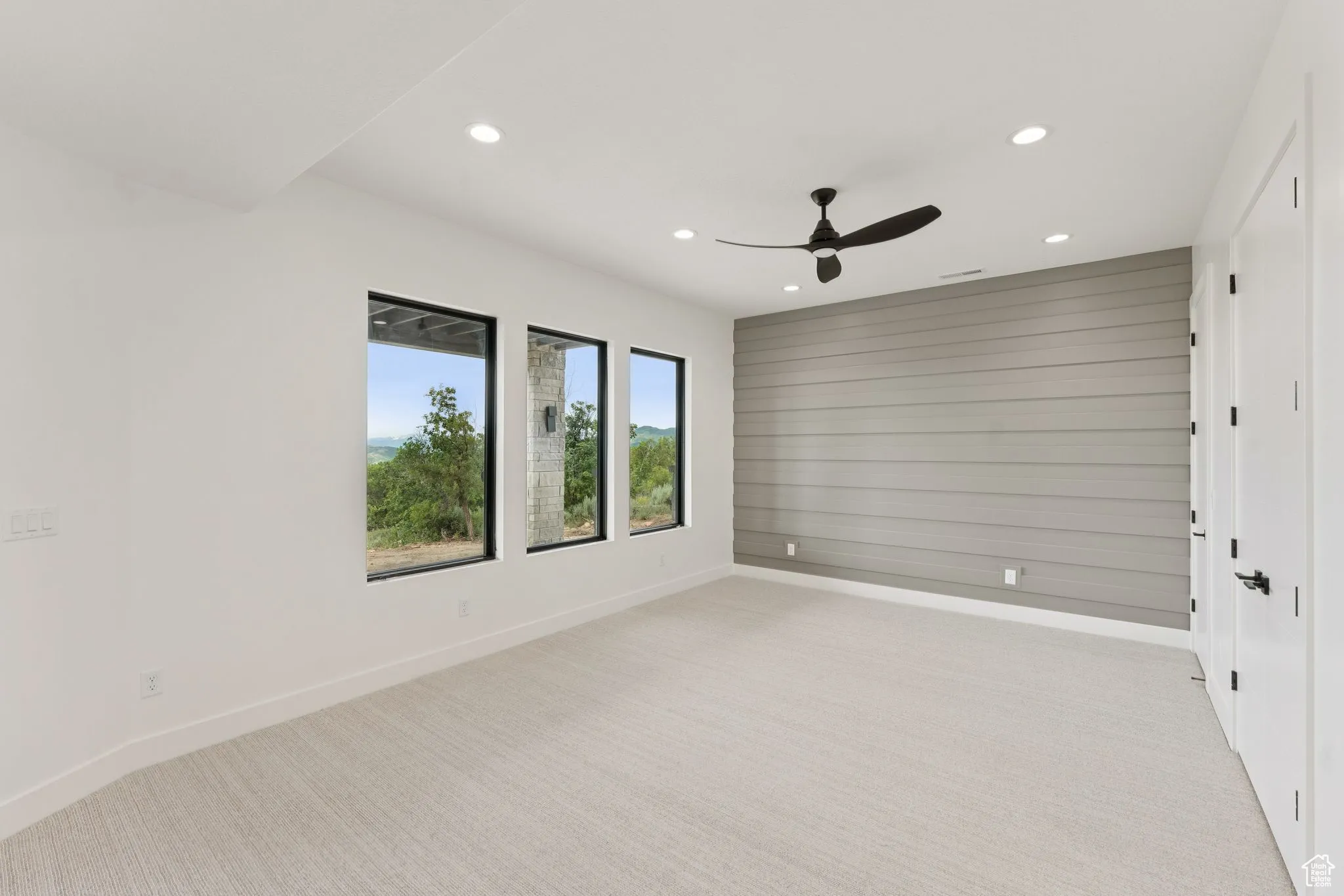 Unfurnished room with recessed lighting, light colored carpet, and a ceiling fan