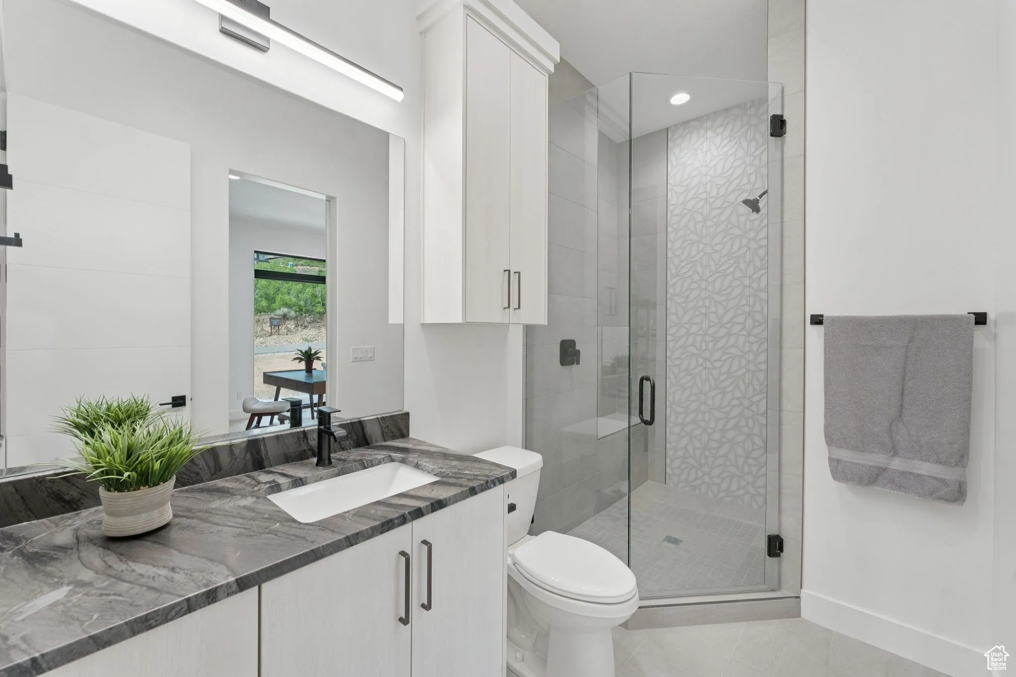 Bathroom featuring vanity, tile patterned flooring, a shower stall, and recessed lighting