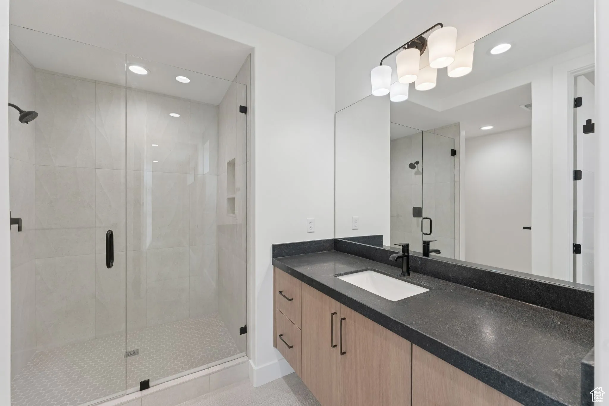 Full bathroom featuring vanity, a stall shower, recessed lighting, and tile patterned flooring