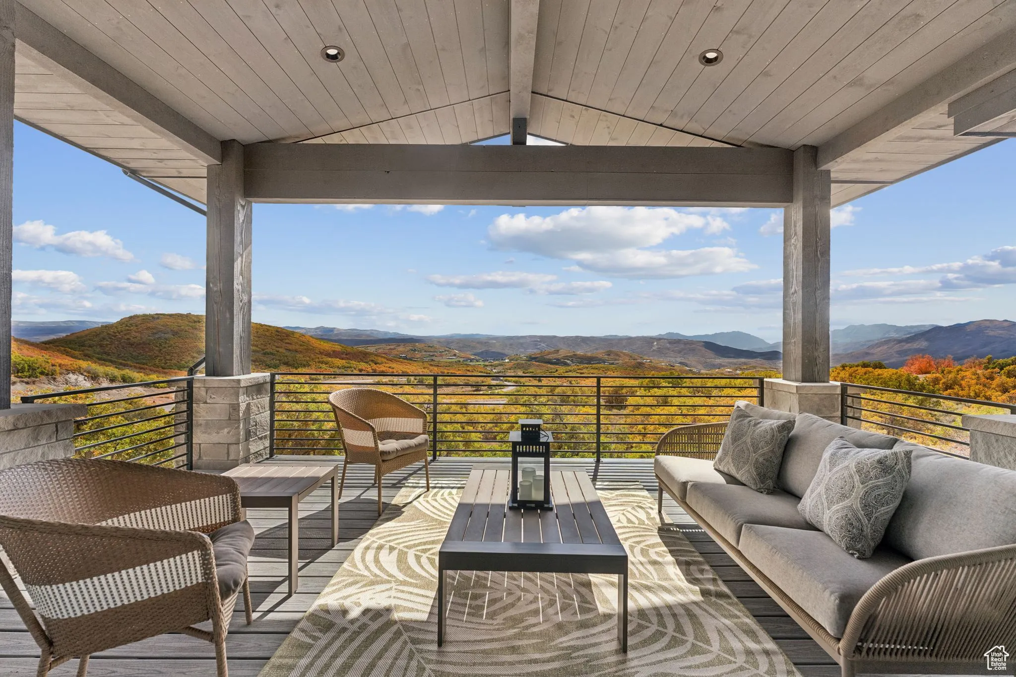 Wooden deck featuring outdoor lounge area, a mountain view, and a patio
