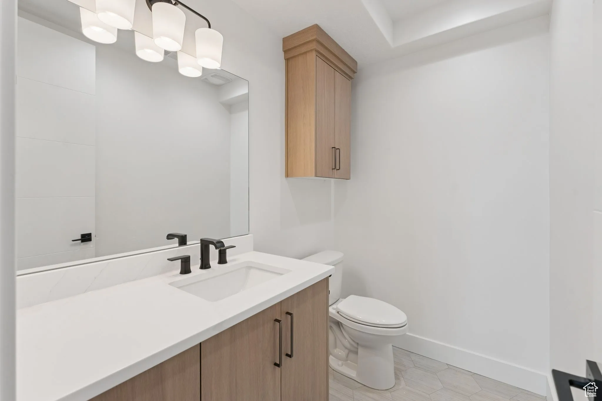 Half bathroom with toilet and vanity