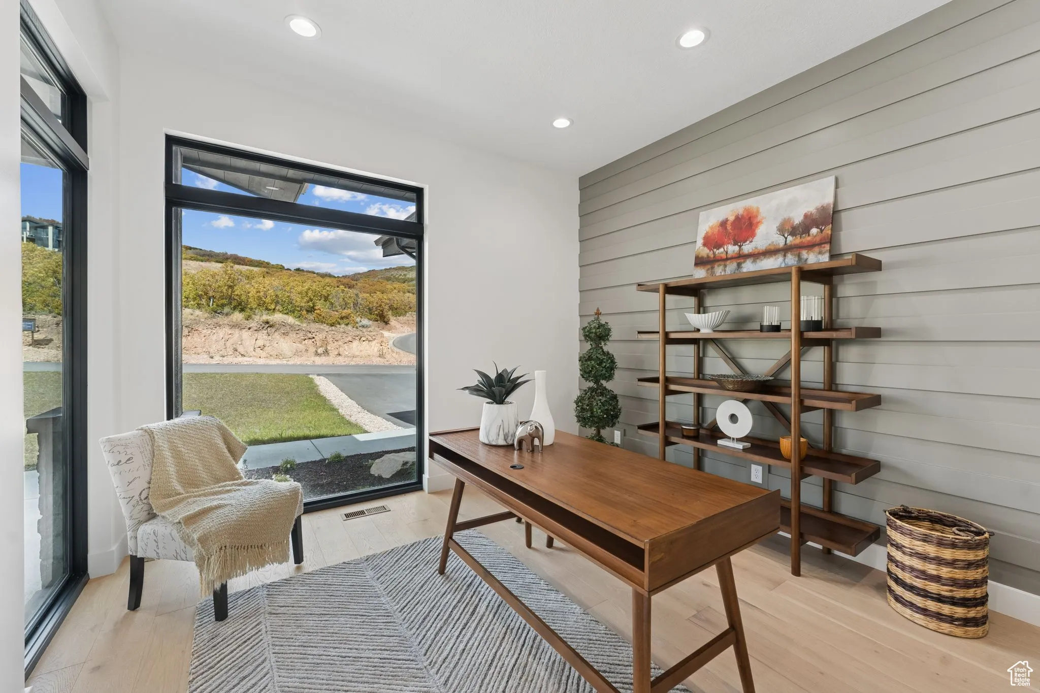 Office space featuring light wood-style floors, recessed lighting, and wooden walls