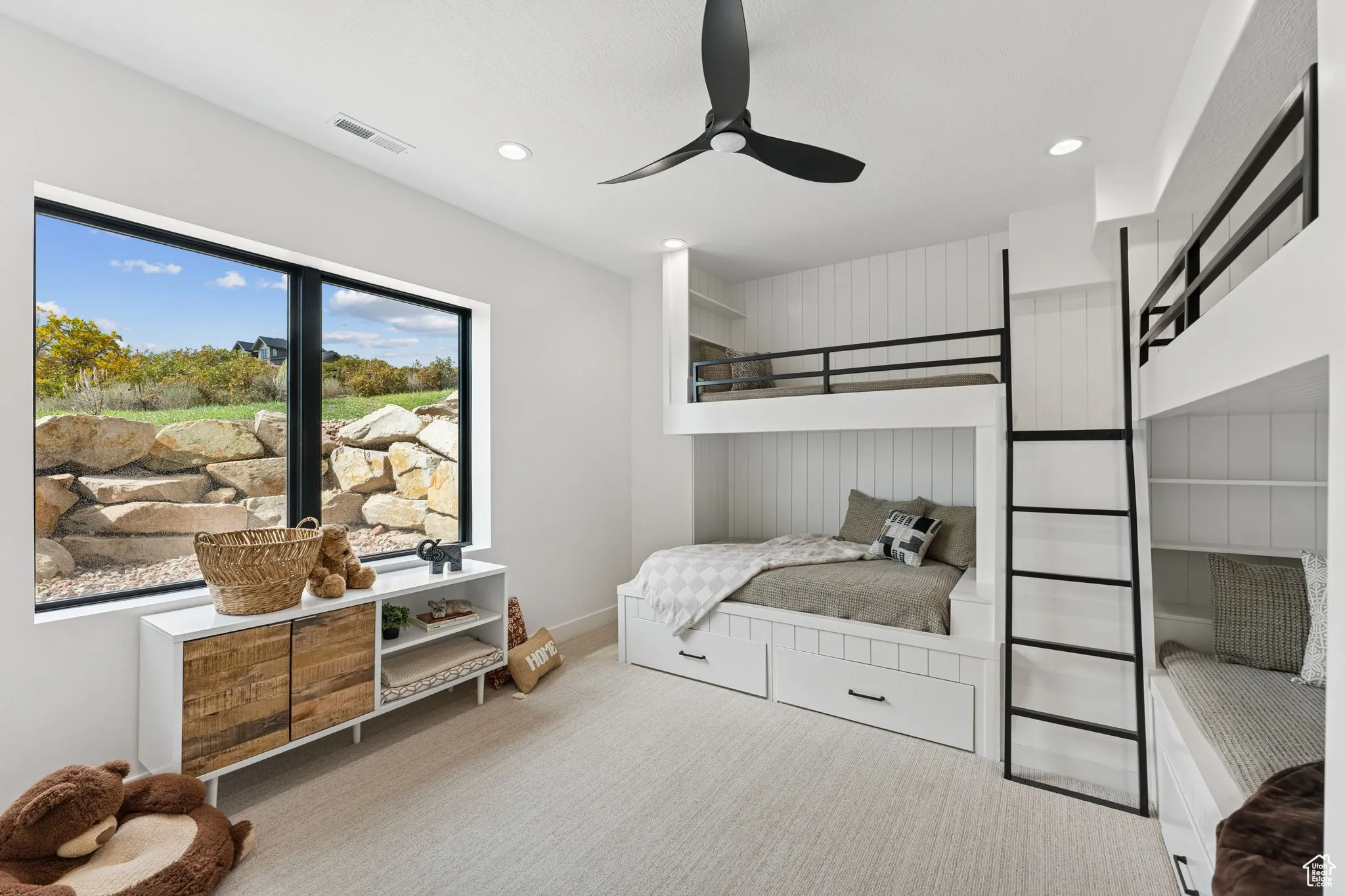 Carpeted bedroom with a ceiling fan and recessed lighting