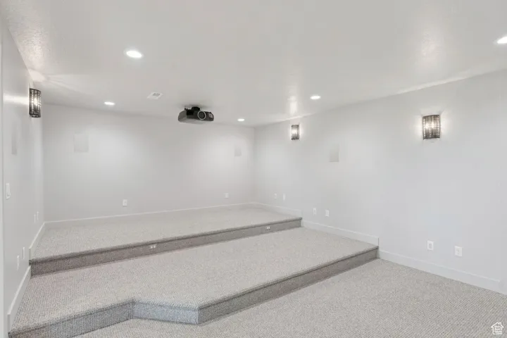 Carpeted spare room with recessed lighting