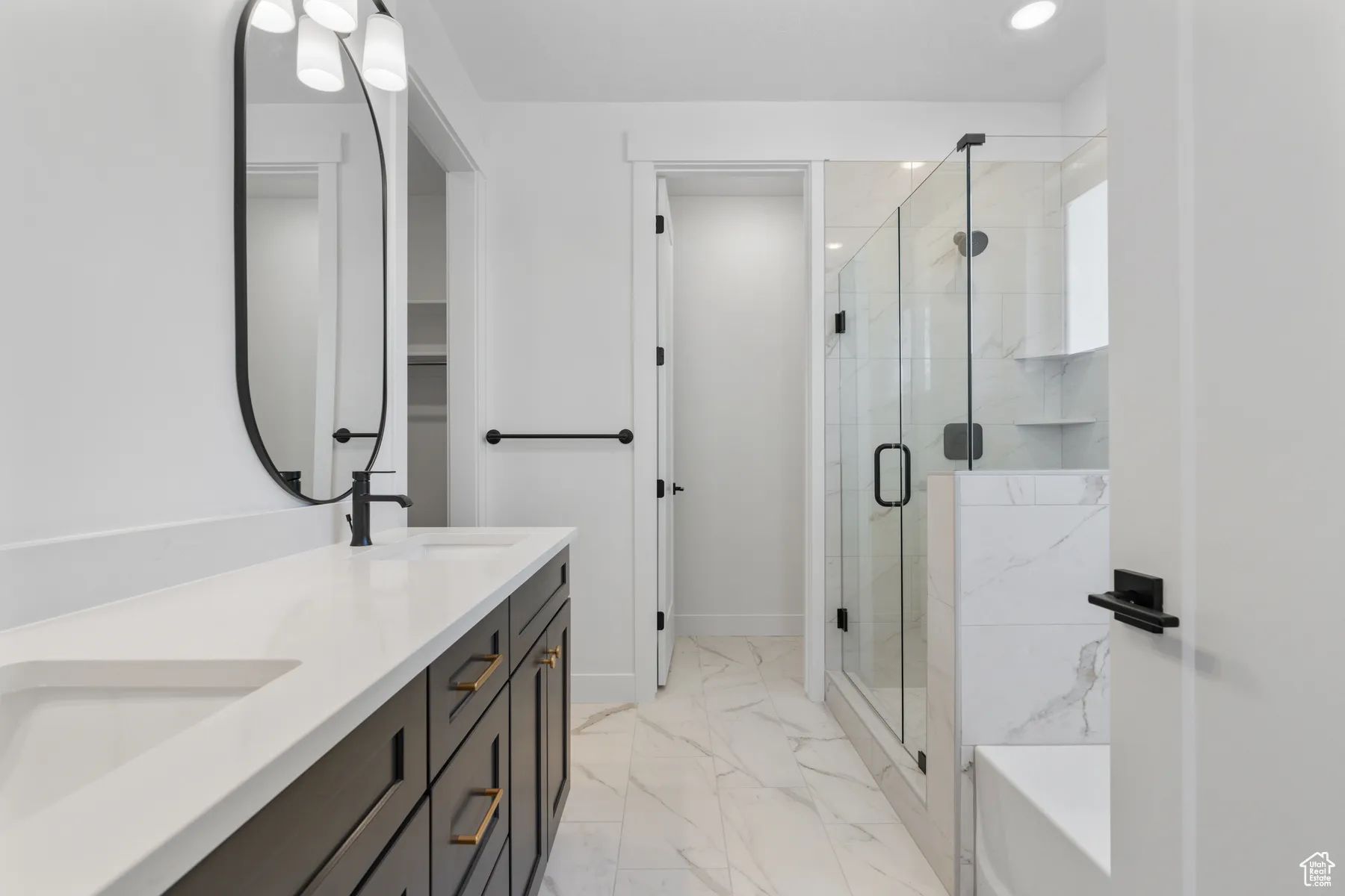 Bathroom with marble finish flooring, double vanity, a stall shower, recessed lighting, and a bath