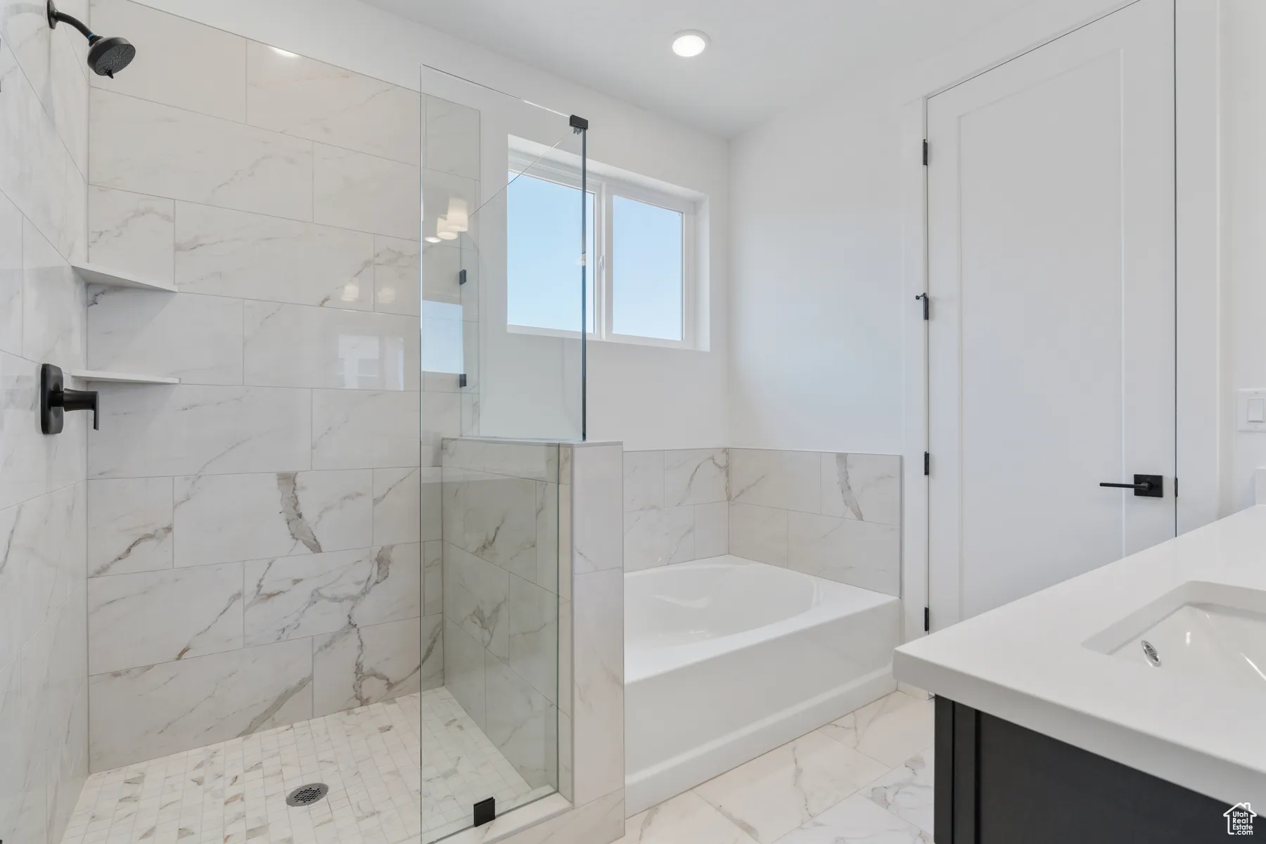 Full bathroom featuring a bath, a marble finish shower, vanity, marble finish floors, and recessed lighting