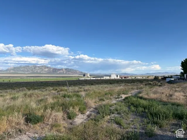 View of mountain backdrop featuring rural landscape