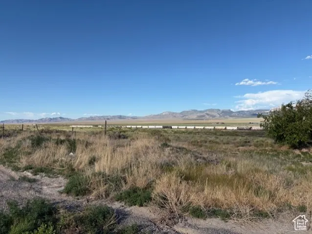 View of mountain backdrop with rural landscape