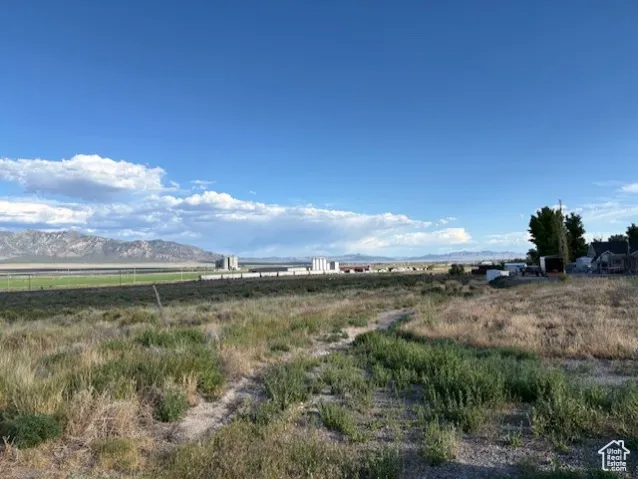 View of yard featuring a rural view and a mountain view