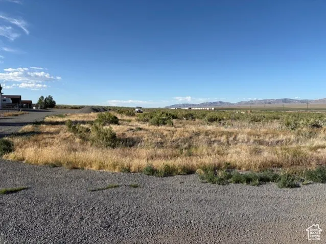 View of local wilderness featuring a mountain backdrop and rural landscape