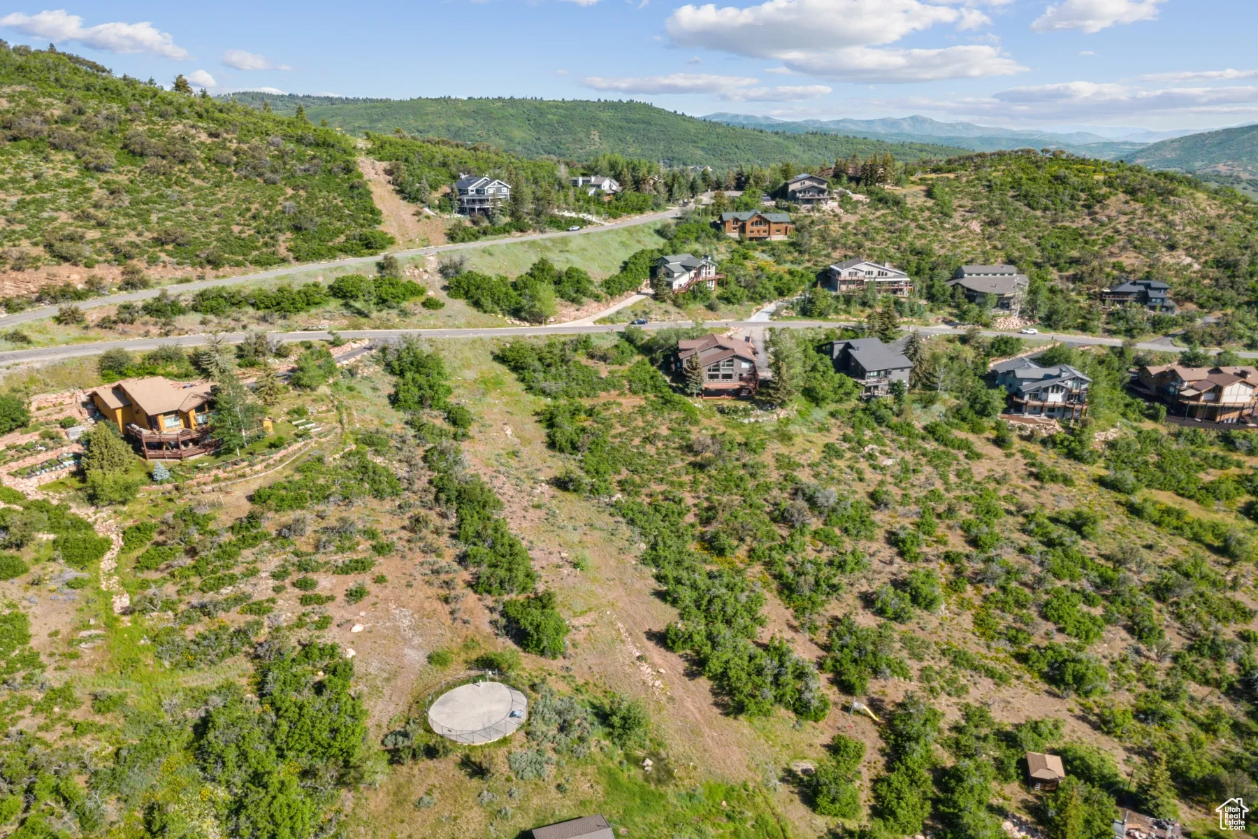Aerial view of property's location with a mountain backdrop