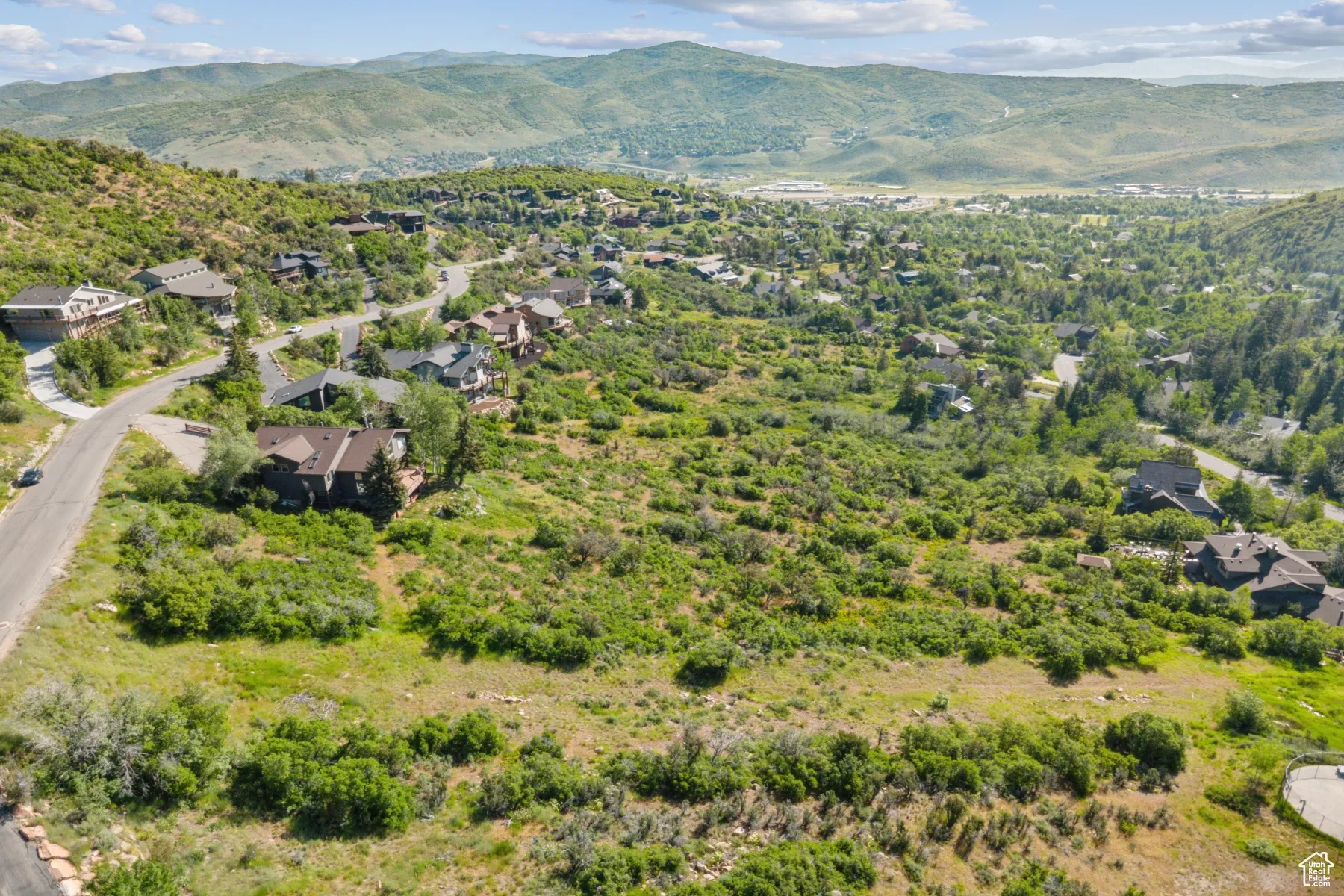 Aerial view of residential area featuring a mountainous background