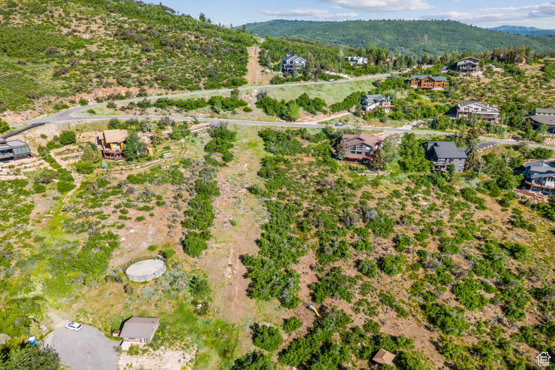 Aerial overview of property's location with a mountainous background