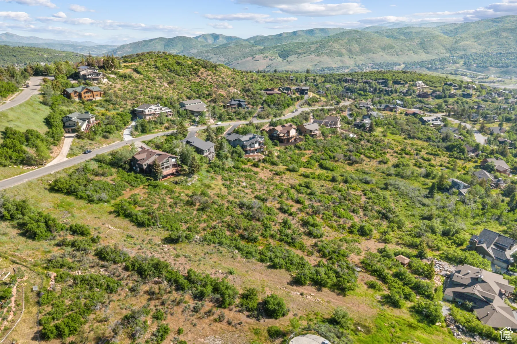View of property location featuring mountains and nearby suburban area