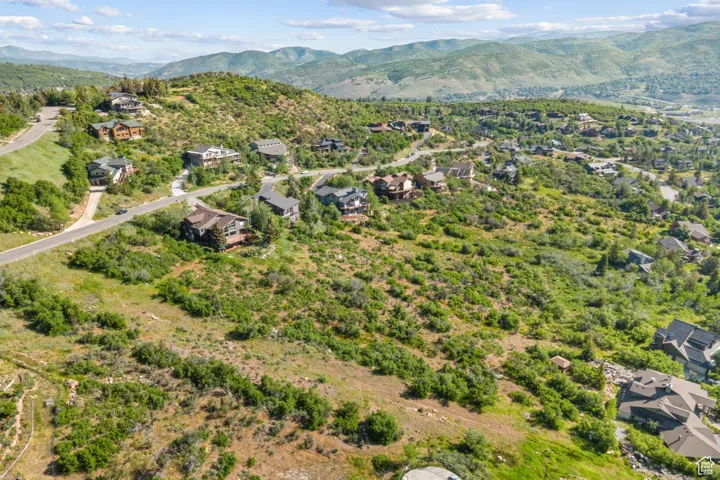 View of property location featuring mountains and nearby suburban area